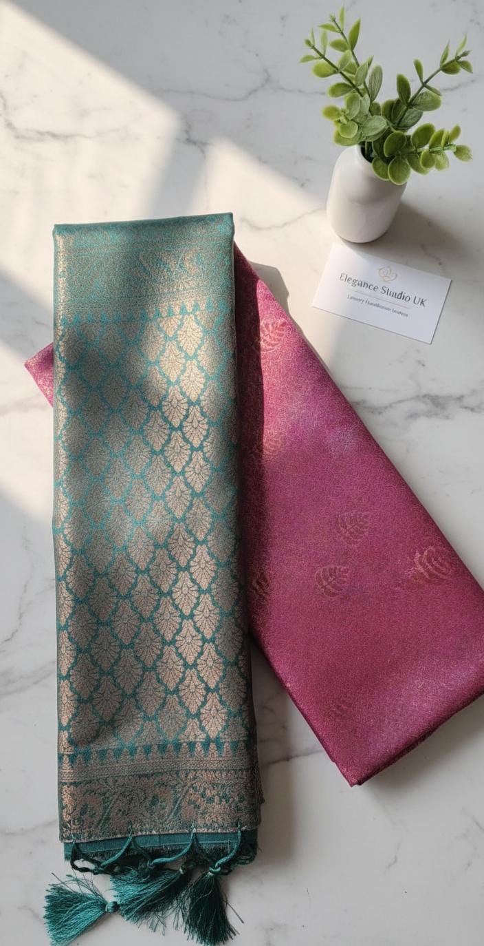 Kubera Silk Regal Motif Heritage Saree with woven silk body featuring subtle self-motifs and an intricately crafted traditional border, styled on a marble surface with minimal décor.