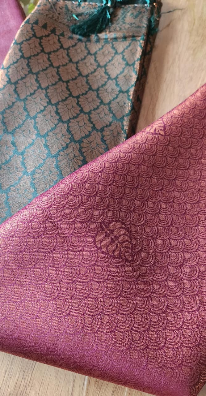 Kubera Silk Regal Motif Heritage Saree with woven silk body featuring subtle self-motifs and an intricately crafted traditional border, styled on a marble surface with minimal décor.