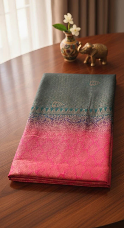 Kubera Silk Dual Weave Legacy Saree featuring a woven silk body with subtle self-patterns and a finely detailed traditional border, neatly styled on a wooden surface with classic décor.