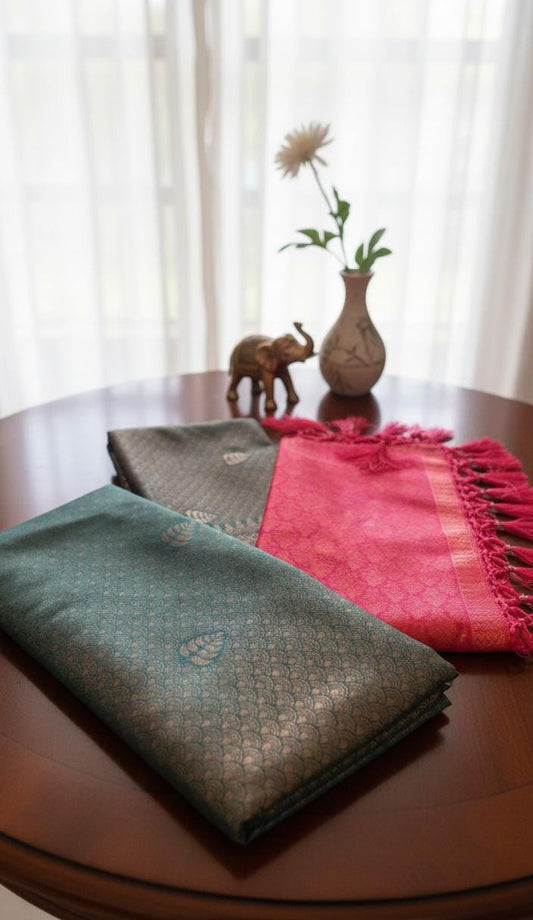 Kubera Silk Dual Weave Legacy Saree featuring a woven silk body with subtle self-patterns and a finely detailed traditional border, neatly styled on a wooden surface with classic décor.