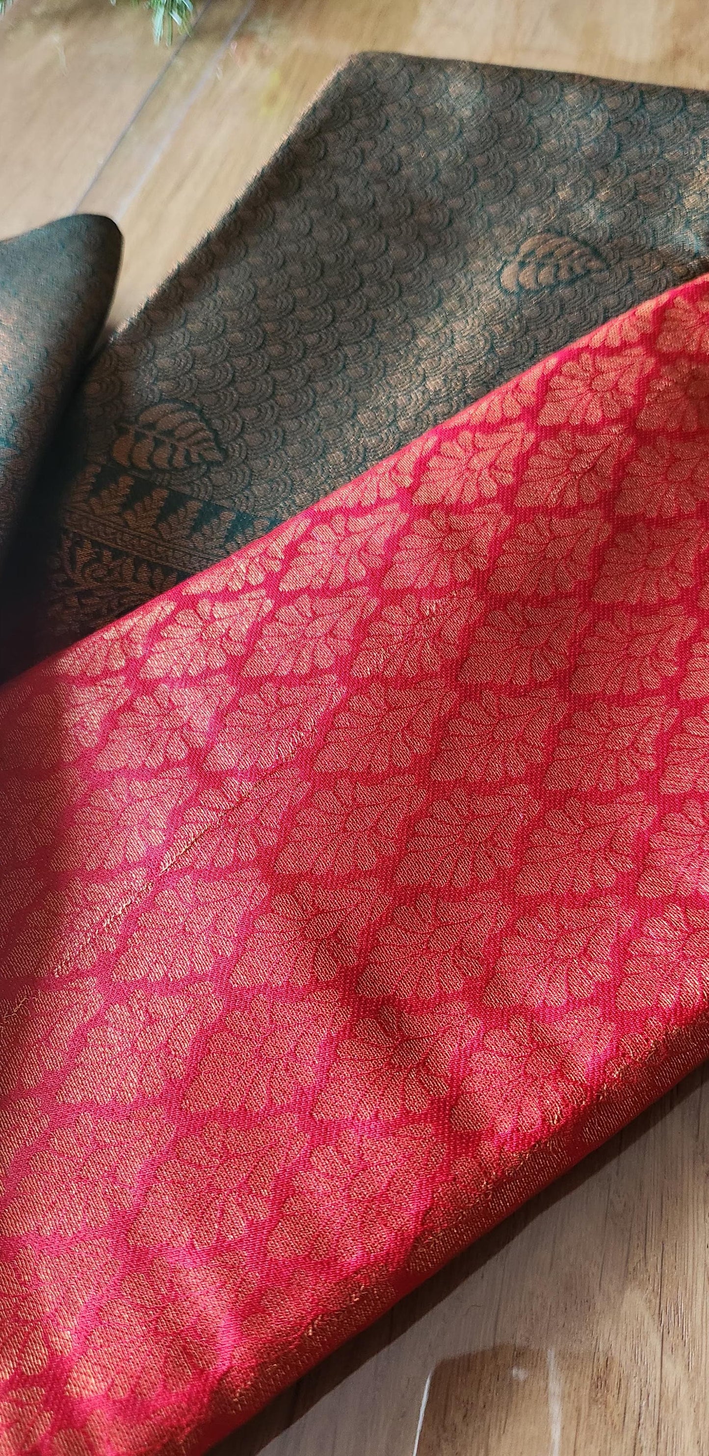 Kubera Silk Dual Weave Legacy Saree featuring a woven silk body with subtle self-patterns and a finely detailed traditional border, neatly styled on a wooden surface with classic décor.