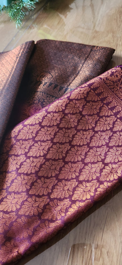 Kubera Silk Heirloom Weave Royale Saree featuring a woven silk body with intricate self-patterns and a finely crafted traditional border, styled on a wooden table with classic décor.