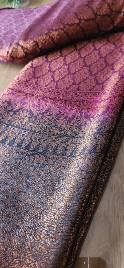Kubera Silk Heirloom Weave Royale Saree featuring a woven silk body with intricate self-patterns and a finely crafted traditional border, styled on a wooden table with classic décor.
