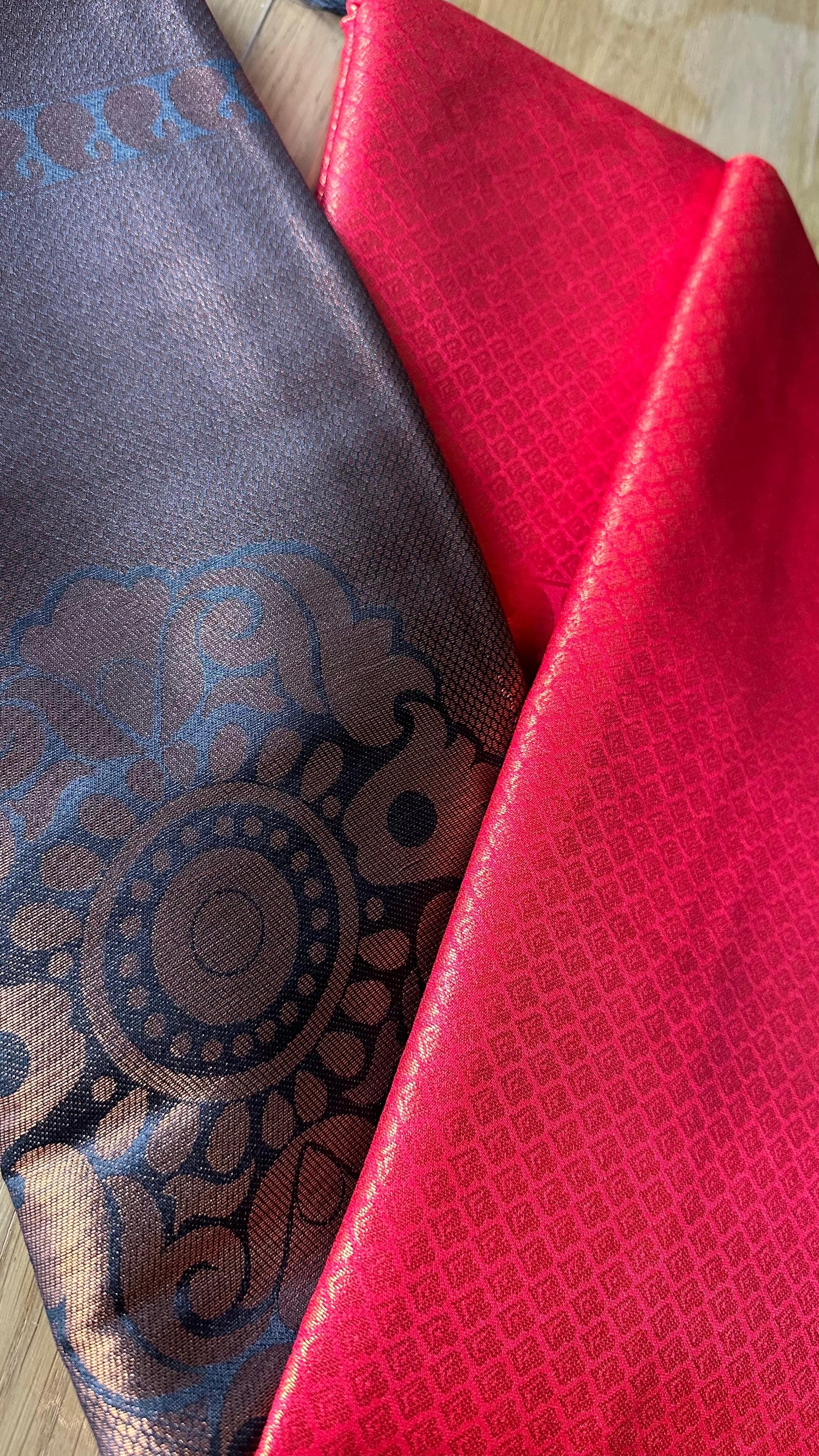 Kubera Silk Royal Contrast Weave Saree featuring a woven silk body with intricate self-patterns and a richly detailed traditional border, styled on a wooden table with classic décor.