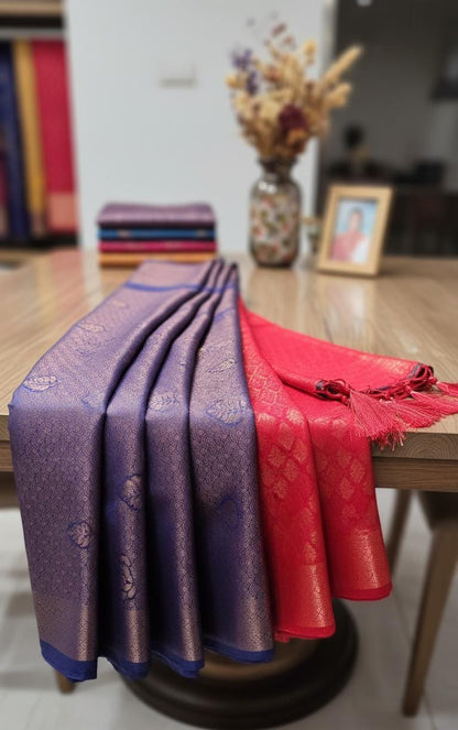 Kubera Silk Royal Contrast Weave Saree featuring a woven silk body with intricate self-patterns and a richly detailed traditional border, styled on a wooden table with classic décor.