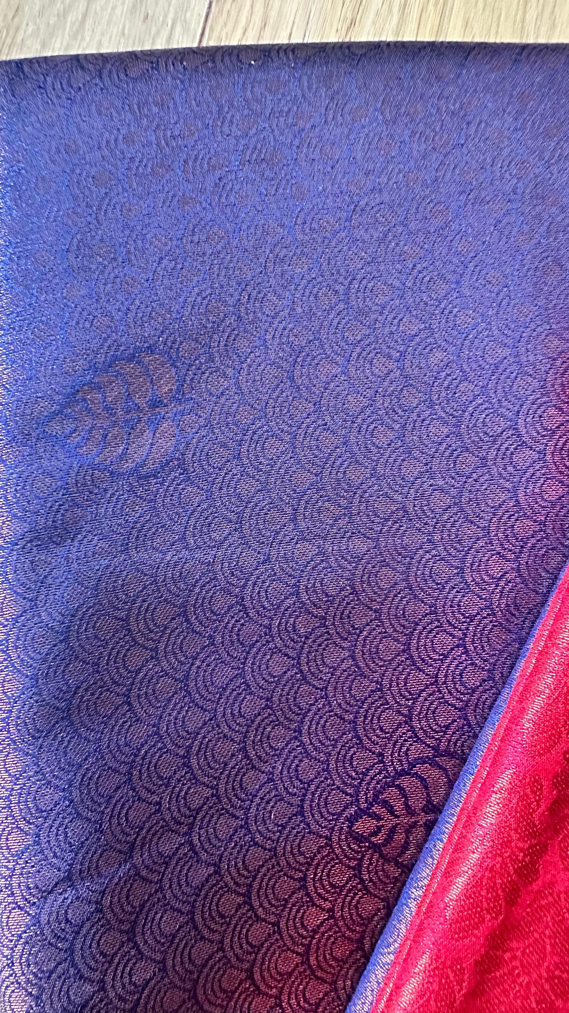 Kubera Silk Royal Contrast Weave Saree featuring a woven silk body with intricate self-patterns and a richly detailed traditional border, styled on a wooden table with classic décor.