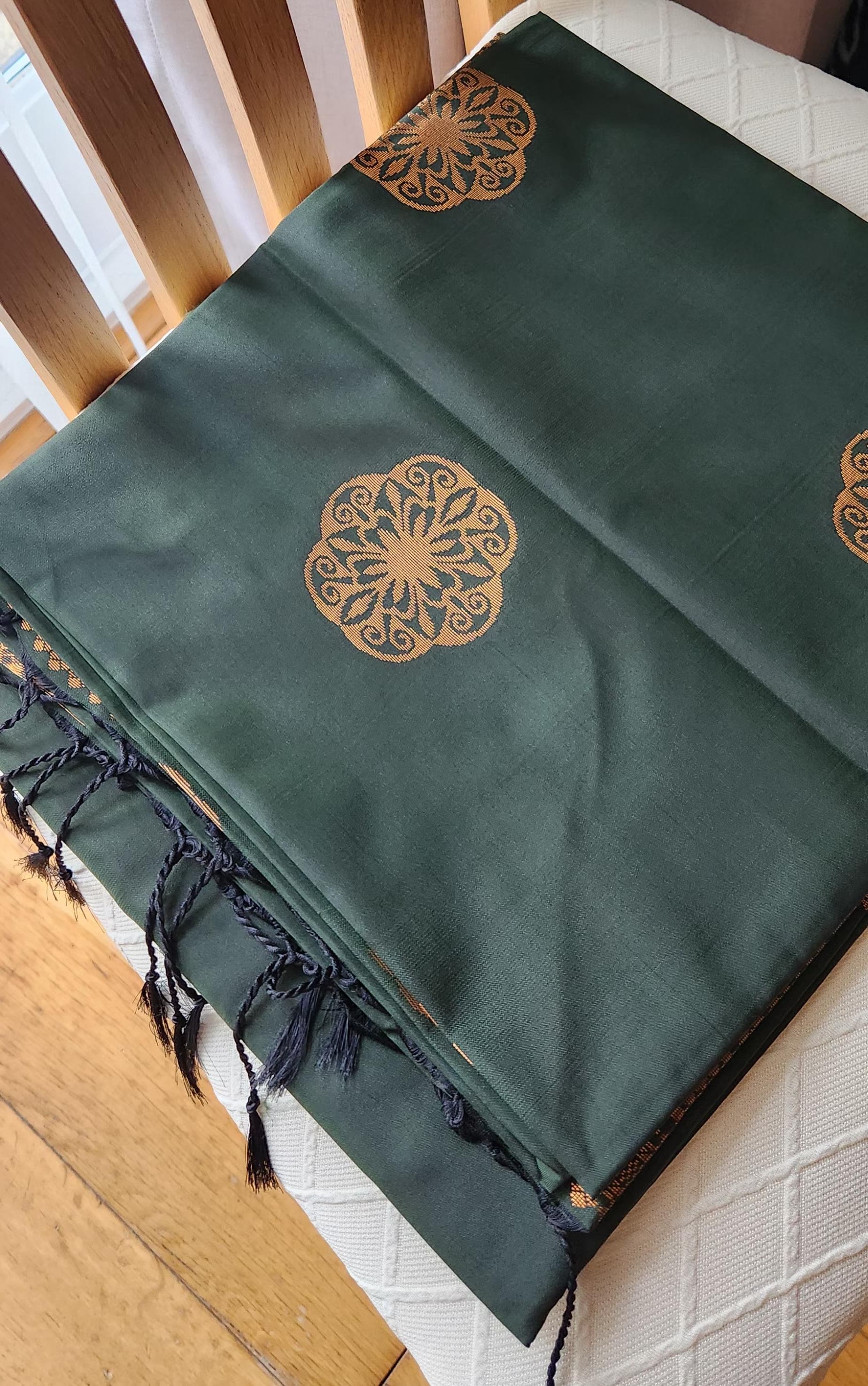 Green soft silk saree showcasing detailed geometric gold pallu