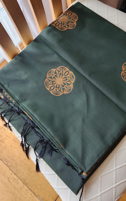 Green soft silk saree showcasing detailed geometric gold pallu