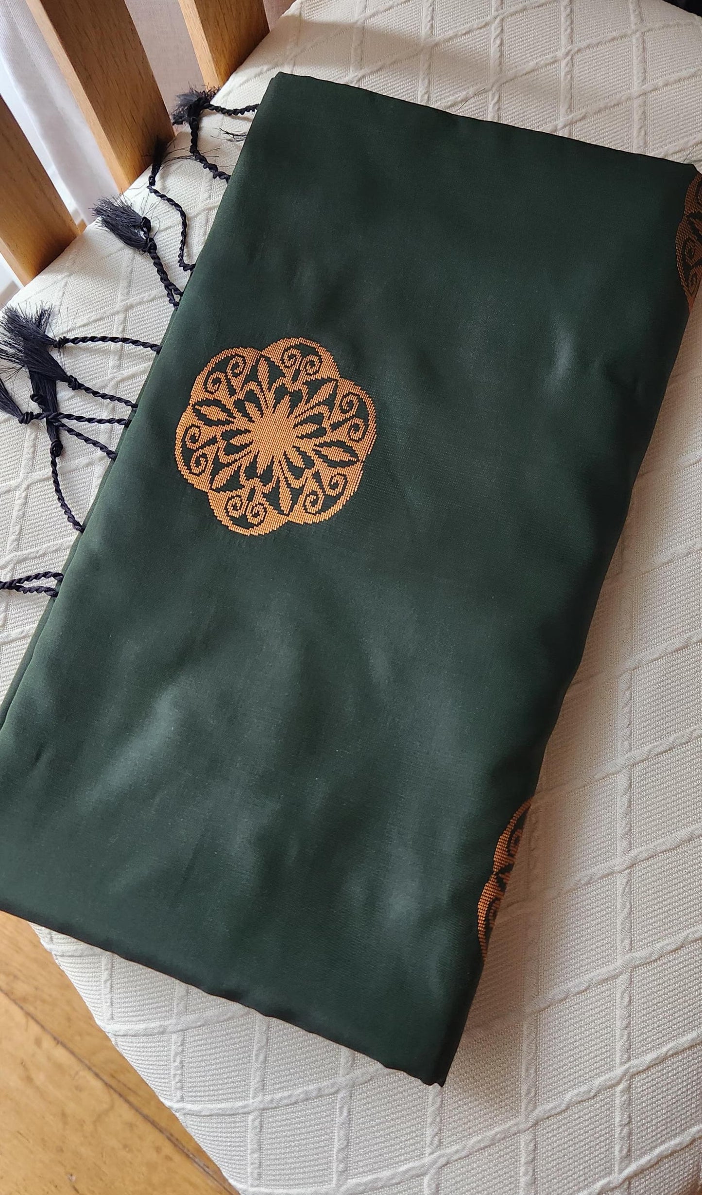 Green soft silk saree showcasing detailed geometric gold pallu