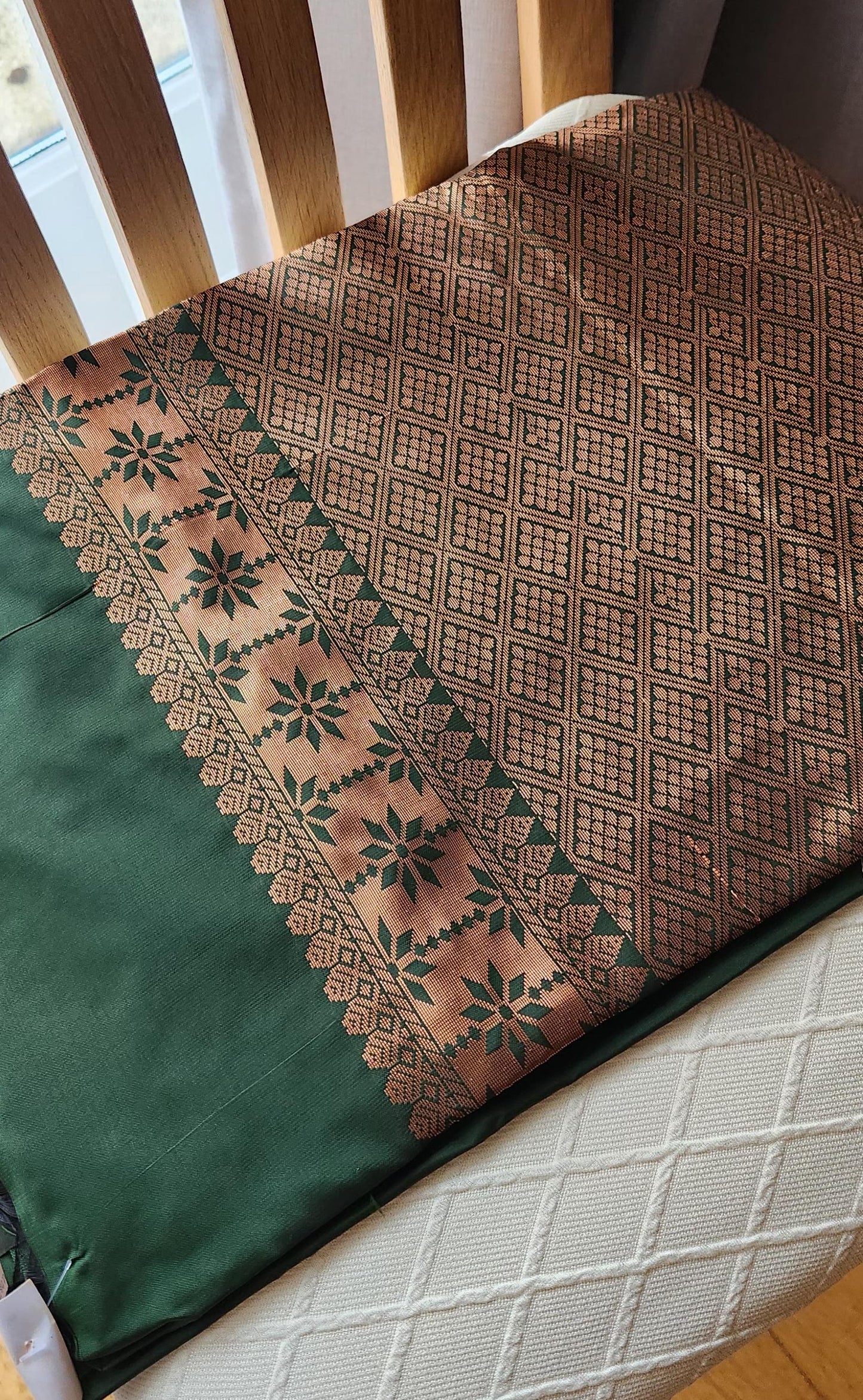 Traditional emerald green silk saree with woven floral motifs