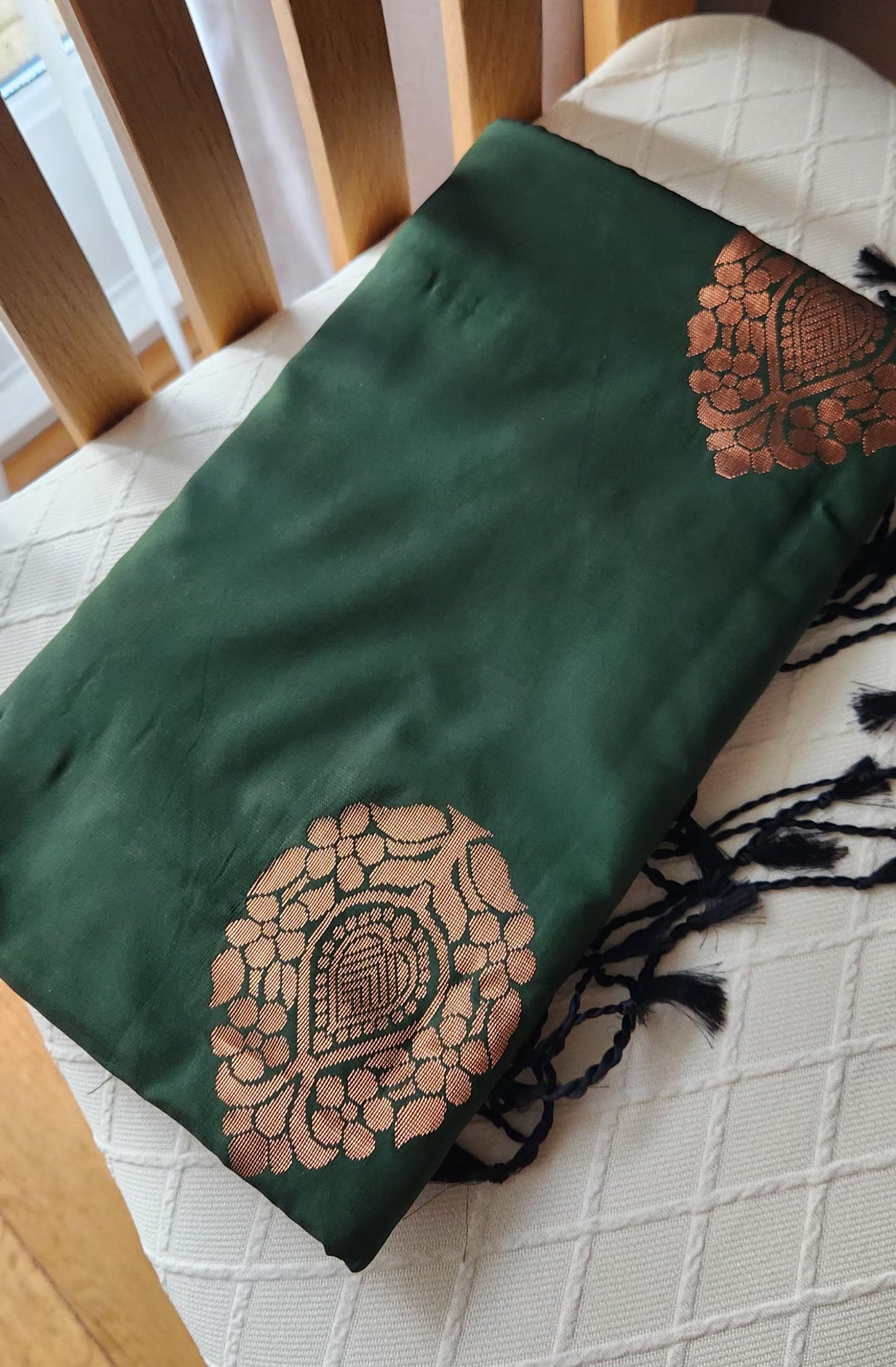 Traditional emerald green silk saree with woven floral motifs