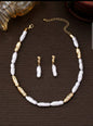 Elegant baroque pearl jewellery set with gold accents featuring statement necklace and matching drop earrings - contemporary organic pearl jewellery UK