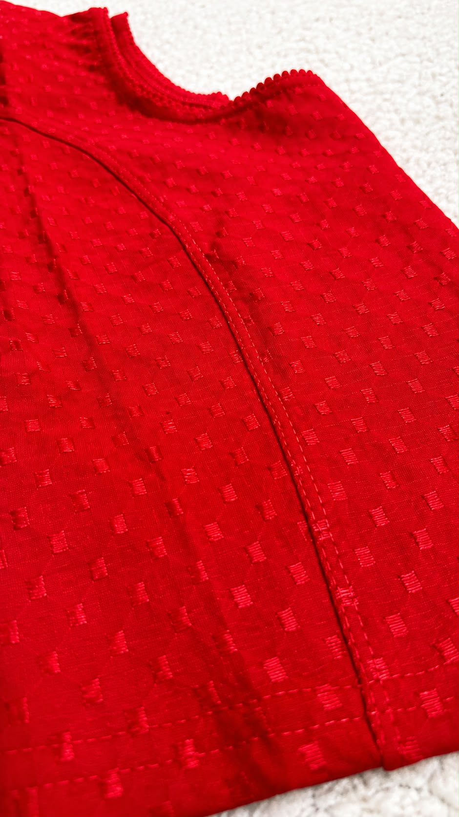 Red textured fabric on a white background