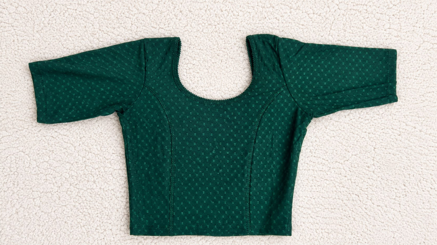 Green polka dot top and pants on a white background