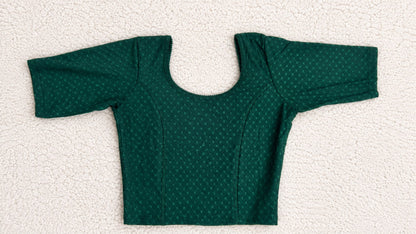 Green polka dot top and pants on a white background