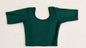 Green polka dot top and pants on a white background