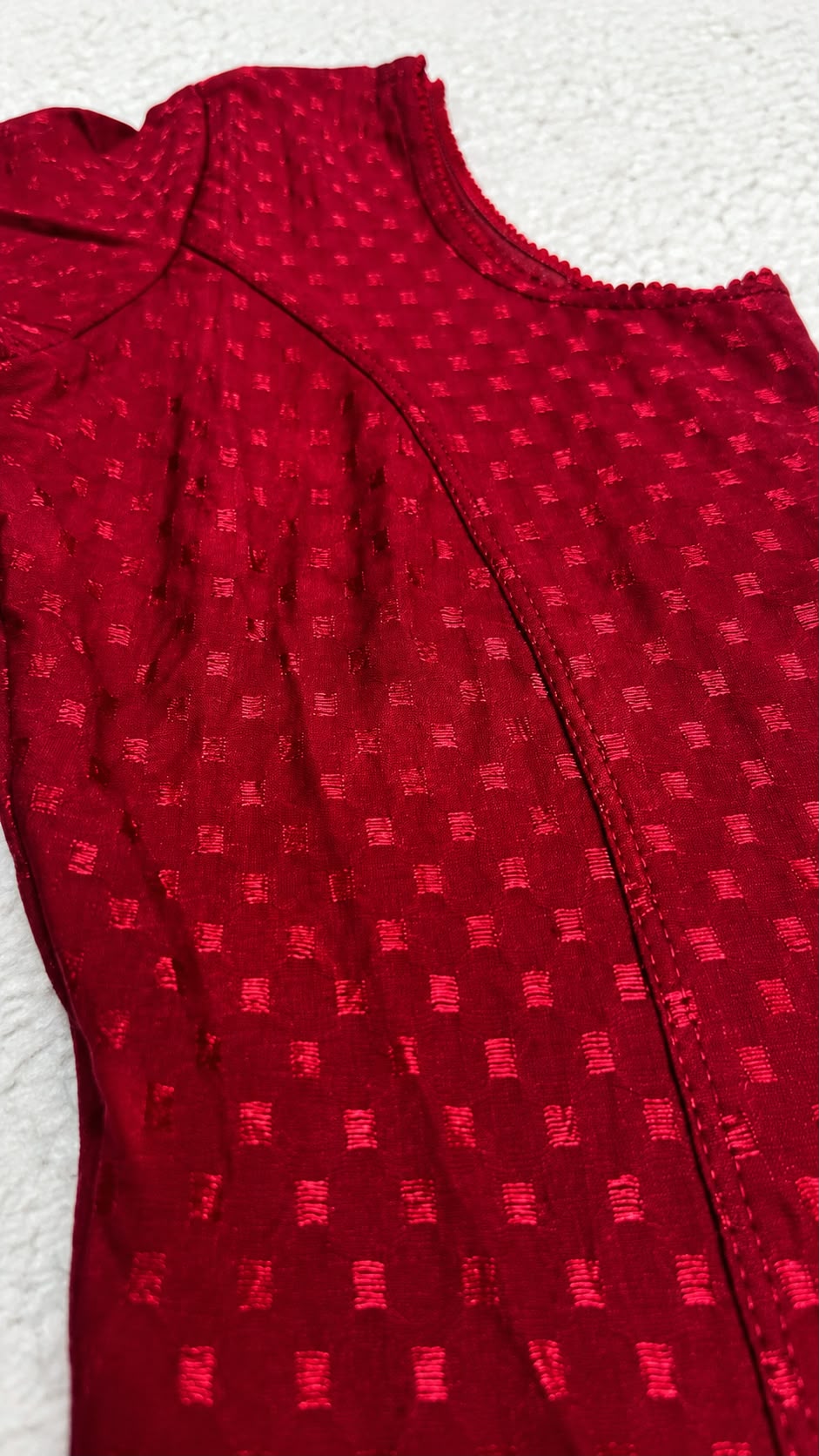 Red polka dot top on a beige background