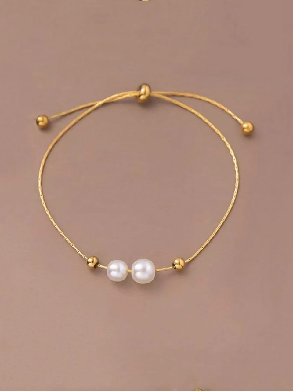 Minimalist gold adjustable bracelet with two white freshwater pearls - contemporary designer jewellery for UK customers