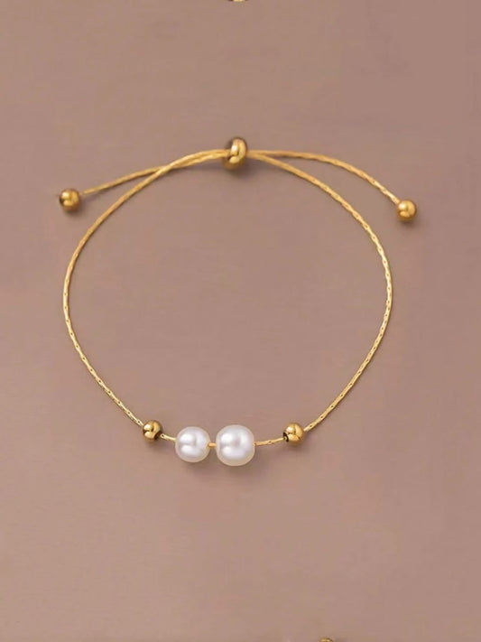 Minimalist gold adjustable bracelet with two white freshwater pearls - contemporary designer jewellery for UK customers