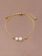 Minimalist gold adjustable bracelet with two white freshwater pearls - contemporary designer jewellery for UK customers