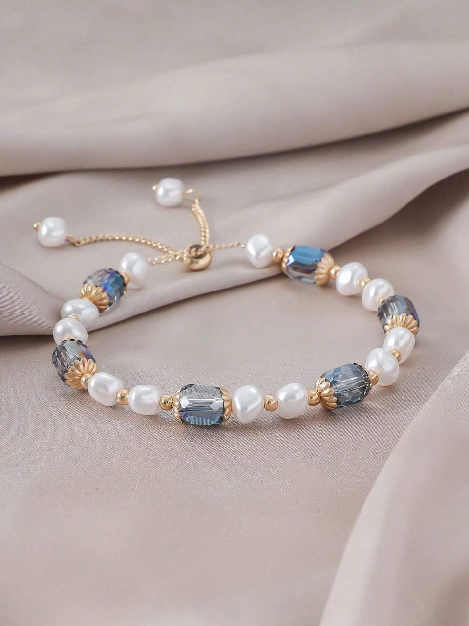 Elegant adjustable bracelet with freshwater pearls, blue crystals and gold-plated accents - luxury designer jewellery for UK customers