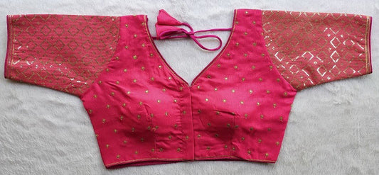 Designer Milan silk readymade blouse with embroidery, back dori tie-up, and padded comfort, displayed flat on fabric backdrop.
