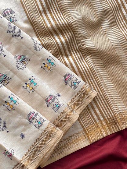 Pure tussar silk saree with all-over Worli embroidery, copper zari border, and zari woven pallu displayed flat.