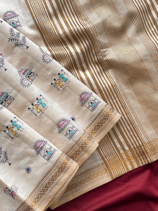Pure tussar silk saree with all-over Worli embroidery, copper zari border, and zari woven pallu displayed flat.