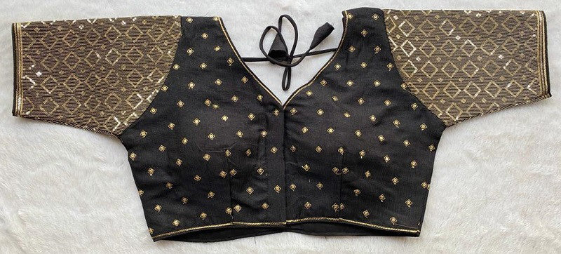 Designer Milan silk readymade blouse with embroidery, back dori tie-up, and padded comfort, displayed flat on fabric backdrop.
