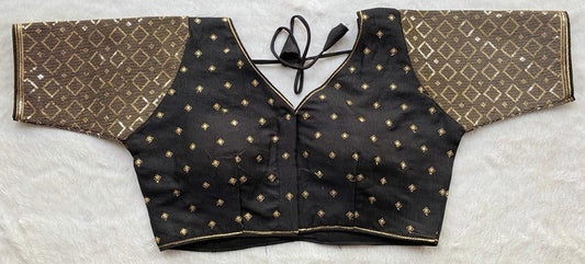 Designer Milan silk readymade blouse with embroidery, back dori tie-up, and padded comfort, displayed flat on fabric backdrop.
