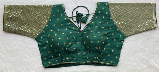 Designer Milan silk readymade blouse with embroidery, back dori tie-up, and padded comfort, displayed flat on fabric backdrop.
