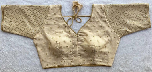 Designer Milan silk readymade blouse with embroidery, back dori tie-up, and padded comfort, displayed flat on fabric backdrop.
