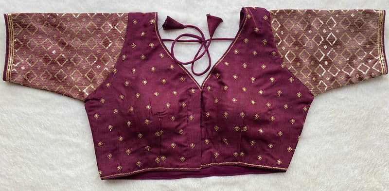 Designer Milan silk readymade blouse with embroidery, back dori tie-up, and padded comfort, displayed flat on fabric backdrop.
