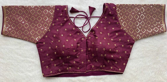 Designer Milan silk readymade blouse with embroidery, back dori tie-up, and padded comfort, displayed flat on fabric backdrop.
