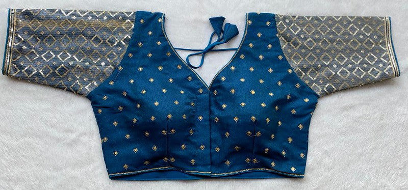 Designer Milan silk readymade blouse with embroidery, back dori tie-up, and padded comfort, displayed flat on fabric backdrop.
