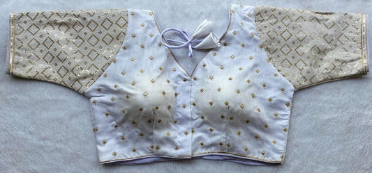 Designer Milan silk readymade blouse with embroidery, back dori tie-up, and padded comfort, displayed flat on fabric backdrop.
